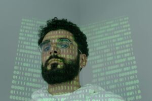 man with binary code projected on his face