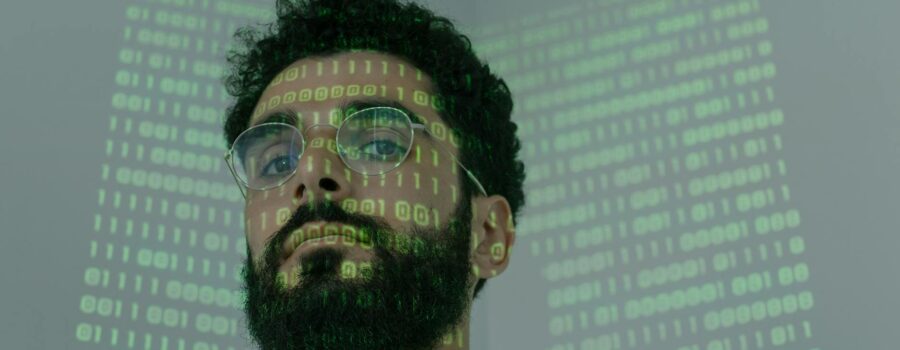 man with binary code projected on his face