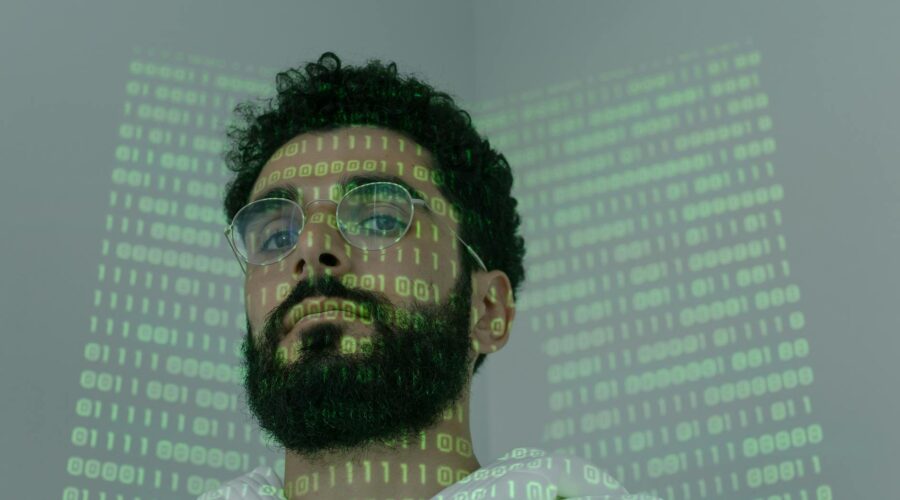 man with binary code projected on his face